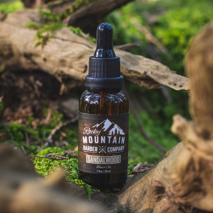 Rocky Mountain Barber Company Sandalwood Beard Oil Outdoors in Nature with Green Moss and Wood