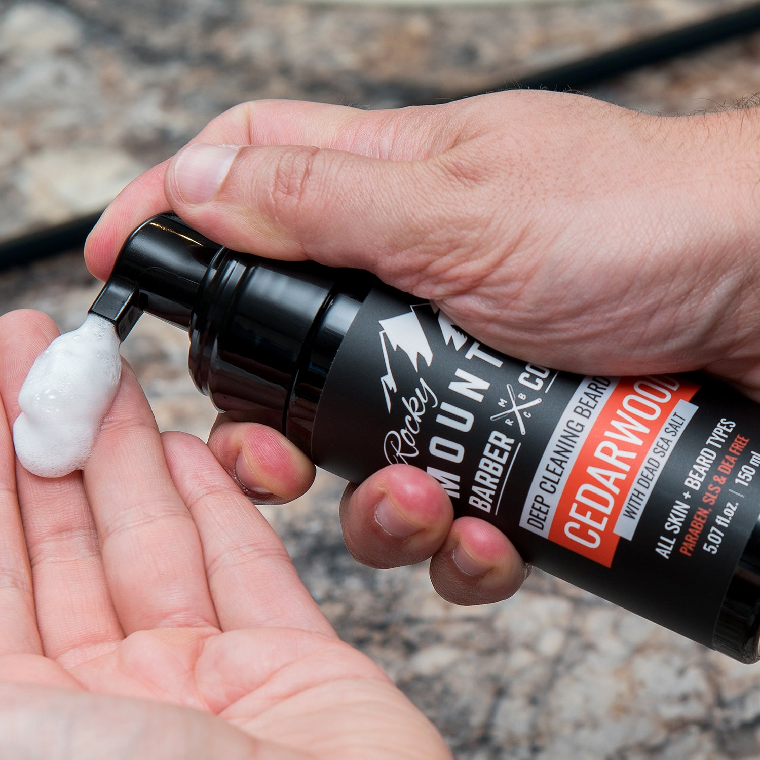 Cedarwood Beard Wash With Foam Being Dispensed Into Hand