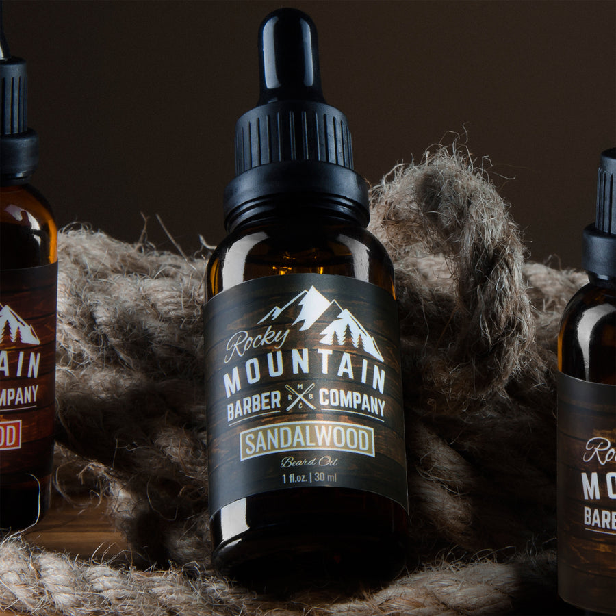 Rocky Mountain Barber Sandalwood Beard Oil Group Shot Lying Down